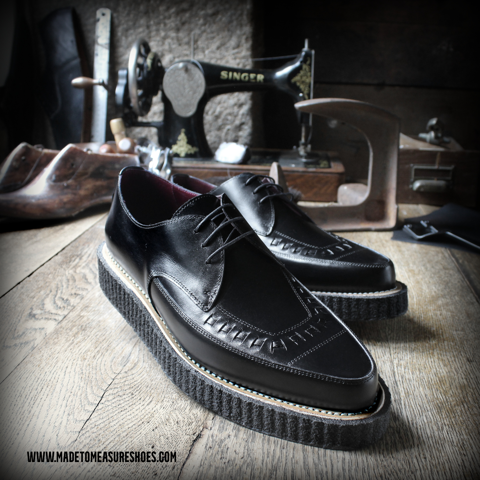 Finished pair of black handmade Goodyear welted creepers in the shoemaking workshop
