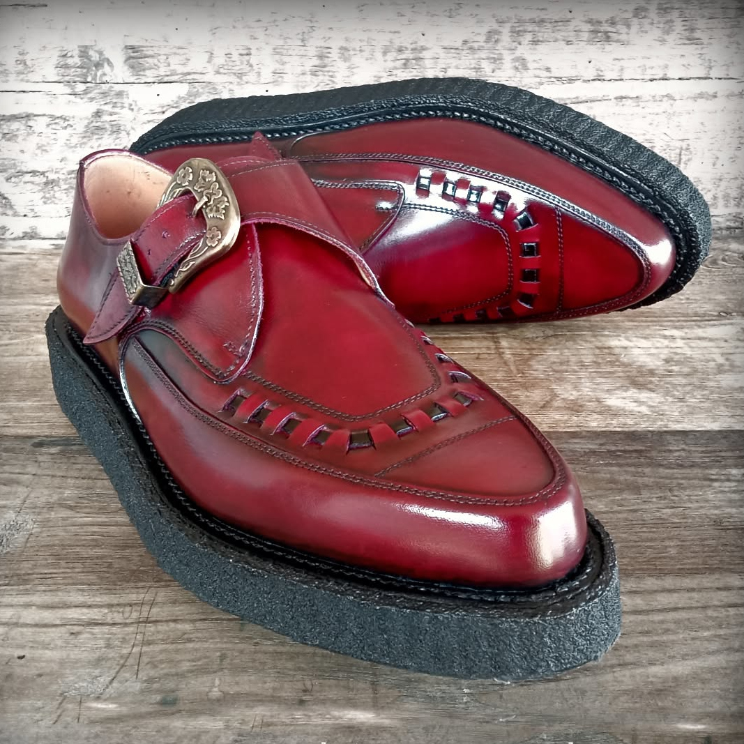 1974 Pointed burgundy Creepers photographed against stone and iron